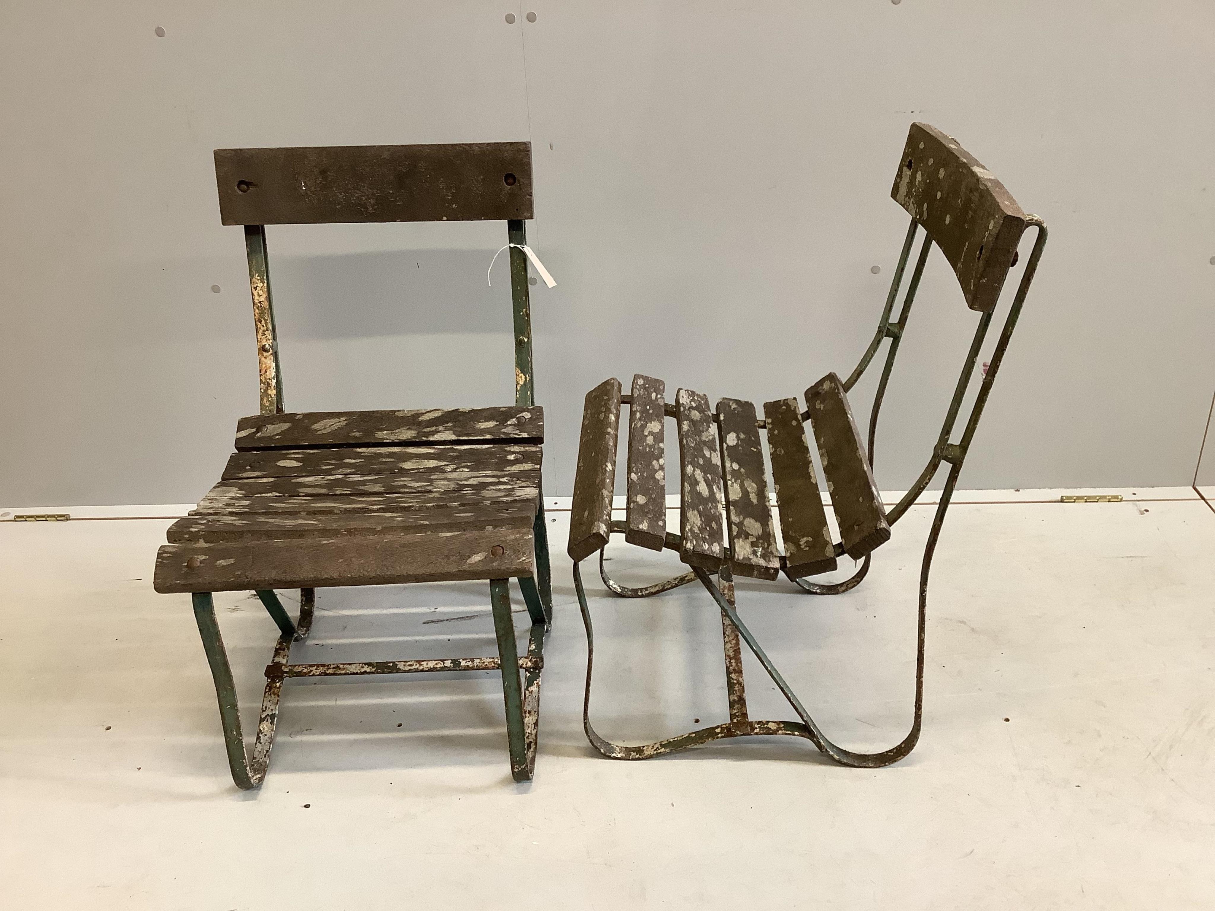A pair of vintage slatted wrought iron garden chairs, width 45cm, depth 45cm, height 76cm. Condition - fair